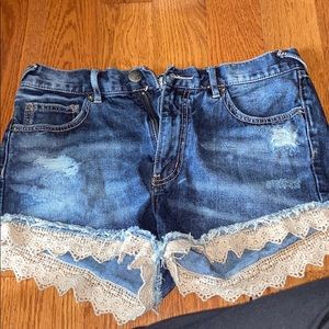 Free people denim shorts with lace trim distressed